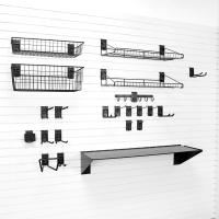 Storage for gardening tools on slatwall with shelves and hooks.