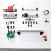 Slat wall hooks for lawn and garden tools in an organized garage.
