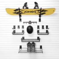 Snowboard rack with hooks and shelves for snowboard storage.