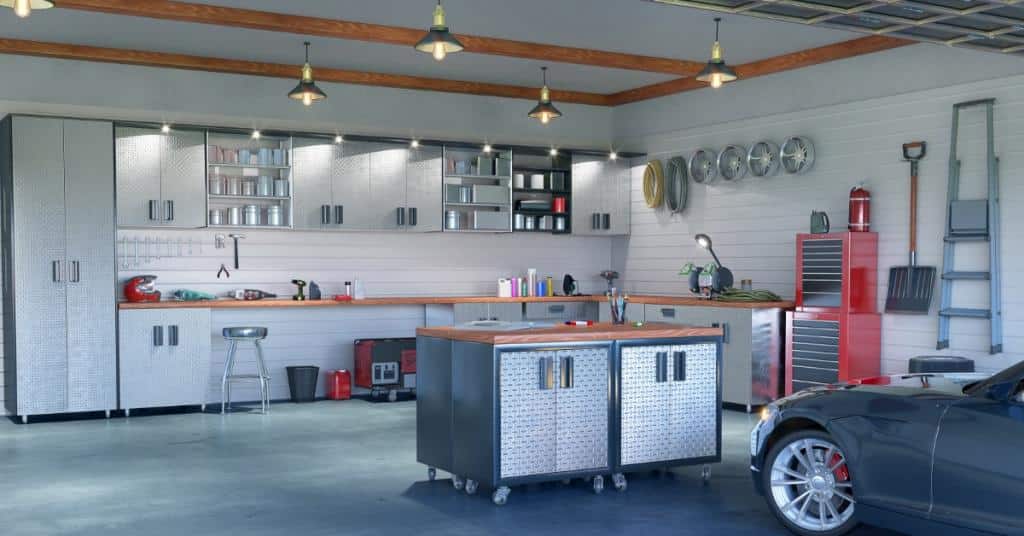 An interior of a garage. To the right of frame there is a car and in the background are several objects hanging on the wall.